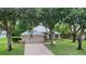 Inviting one-story home featuring a two-car garage and beautiful landscaping enhancing curb appeal at 24 Katrinas Dr, Ormond Beach, FL 32174