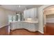 Kitchen with white cabinets, quartz countertops, stainless dishwasher, and view to open patio area at 24 Katrinas Dr, Ormond Beach, FL 32174