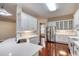 Bright kitchen features white cabinets, stainless steel appliances, and quartz countertops with wood floors at 24 Katrinas Dr, Ormond Beach, FL 32174