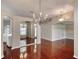 Spacious living room features hardwood floors, decorative lighting fixtures, and views to kitchen at 24 Katrinas Dr, Ormond Beach, FL 32174