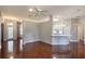 Open-concept living room with hardwood floors and adjacent kitchen with bar seating at 24 Katrinas Dr, Ormond Beach, FL 32174