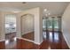 Open-concept living room with hardwood floors and arched doorway to kitchen at 24 Katrinas Dr, Ormond Beach, FL 32174