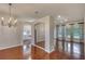 Spacious living room features hardwood floors, decorative lighting and views to kitchen and open patio area at 24 Katrinas Dr, Ormond Beach, FL 32174