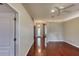 View of living room with hardwood floors, ceiling fan and well-lit entryway at 24 Katrinas Dr, Ormond Beach, FL 32174