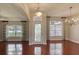 Bright living room features decorative front door and windows with wood flooring at 24 Katrinas Dr, Ormond Beach, FL 32174
