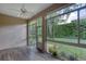 Sunroom with tile floors, ceiling fan, and large windows overlooking beautiful backyard at 24 Katrinas Dr, Ormond Beach, FL 32174