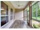 Sunroom with tile floors, ceiling fan, and many windows overlooking green lawn at 24 Katrinas Dr, Ormond Beach, FL 32174
