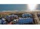 Aerial view of colorful beachfront townhomes and the surrounding community near the ocean at 3000 Ocean Shore Blvd # 18, Ormond Beach, FL 32176