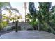 Backyard with lush tropical landscaping, plants, and a wooden deck with an inviting atmosphere at 3000 Ocean Shore Blvd # 18, Ormond Beach, FL 32176