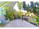 Backyard deck with seating surrounded by lush landscaping and tropical foliage at 3000 Ocean Shore Blvd # 18, Ormond Beach, FL 32176