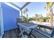 Charming balcony featuring outdoor seating with a view of palm trees and a residential street at 3000 Ocean Shore Blvd # 18, Ormond Beach, FL 32176