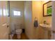 Small half bathroom featuring a pedestal sink and a toilet at 3000 Ocean Shore Blvd # 18, Ormond Beach, FL 32176