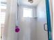 Bathroom shower with white brick-pattern tiles, rainfall shower head, and glass door at 3000 Ocean Shore Blvd # 18, Ormond Beach, FL 32176