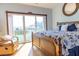 Bright bedroom with a wooden frame bed, ocean view, and a comfortable armchair at 3000 Ocean Shore Blvd # 18, Ormond Beach, FL 32176