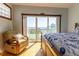 Bright bedroom with a wooden frame bed and ocean view at 3000 Ocean Shore Blvd # 18, Ormond Beach, FL 32176
