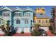 Charming blue and yellow townhomes with garages and balconies offer a coastal living experience at 3000 Ocean Shore Blvd # 18, Ormond Beach, FL 32176