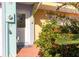 Close up of the front door framed by lush, tropical landscaping at 3000 Ocean Shore Blvd # 18, Ormond Beach, FL 32176
