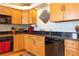 Functional kitchen featuring wood cabinets and black countertops at 3000 Ocean Shore Blvd # 18, Ormond Beach, FL 32176