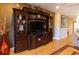 Living room featuring a wooden entertainment center, hardwood floors, and cozy interior design at 3000 Ocean Shore Blvd # 18, Ormond Beach, FL 32176