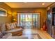 Living room with hardwood floors, stylish furnishings, and sliding glass doors that lead to a balcony at 3000 Ocean Shore Blvd # 18, Ormond Beach, FL 32176