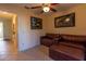 Comfortable living room area with tile floors, ceiling fan, and leather furniture at 3000 Ocean Shore Blvd # 18, Ormond Beach, FL 32176