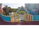 Pool area with colorful gate and fence leading to the community pool at 3000 Ocean Shore Blvd # 18, Ormond Beach, FL 32176