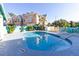 Inviting pool area with comfortable seating and lush tropical landscaping at 3000 Ocean Shore Blvd # 18, Ormond Beach, FL 32176