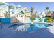 Tranquil pool area surrounded by colorful homes and vibrant, tropical foliage at 3000 Ocean Shore Blvd # 18, Ormond Beach, FL 32176