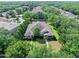 Aerial view of the home nestled among lush greenery, showcasing the community's serene and tree-filled environment at 3132 Connemara Dr, Ormond Beach, FL 32174