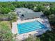 Aerial view showcasing a swimming pool and tennis courts, providing a range of recreational activities at 3132 Connemara Dr, Ormond Beach, FL 32174