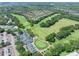 An aerial view of the golf course including the club house, tennis courts, and the golf greens at 3132 Connemara Dr, Ormond Beach, FL 32174