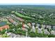 An aerial view of a home in a neighborhood located on the golf course with mature tree coverage and a view of the ocean at 3132 Connemara Dr, Ormond Beach, FL 32174