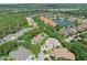 A high angle showing the lush landscaping surrounding this home in a well-manicured neighborhood, with a pond nearby at 3132 Connemara Dr, Ormond Beach, FL 32174