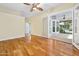 Bedroom features wood floors, ceiling fan, and glass doors leading to a porch at 3132 Connemara Dr, Ormond Beach, FL 32174