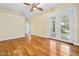 Bedroom features wood floors, ceiling fan, and glass doors to patio at 3132 Connemara Dr, Ormond Beach, FL 32174