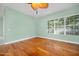Bright bedroom featuring a ceiling fan and a large window at 3132 Connemara Dr, Ormond Beach, FL 32174