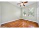 Comfortable bedroom with ceiling fan, two windows and hardwood floors at 3132 Connemara Dr, Ormond Beach, FL 32174