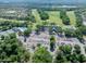 Aerial view of the clubhouse and amenities, including the pool, tennis courts, and parking area at 3132 Connemara Dr, Ormond Beach, FL 32174