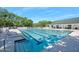 Community pool with crystal-clear water, surrounded by comfortable lounge chairs and picturesque scenery at 3132 Connemara Dr, Ormond Beach, FL 32174