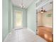 Elegant foyer featuring tile flooring, chandelier lighting and decorative glass front door at 3132 Connemara Dr, Ormond Beach, FL 32174