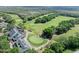 Aerial view of the golf course and country club with mature trees and lush landscaping at 3132 Connemara Dr, Ormond Beach, FL 32174