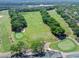 Scenic aerial of the golf course featuring mature trees and well-manicured greens at 3132 Connemara Dr, Ormond Beach, FL 32174