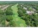 A lovely view of a well-kept golf course with mature trees lining the fairway in a quiet, established neighborhood at 3132 Connemara Dr, Ormond Beach, FL 32174