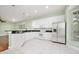 Well-lit kitchen features stainless steel appliances, a granite-top island and tile flooring at 3132 Connemara Dr, Ormond Beach, FL 32174