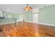 Open living area with light green walls, wood floors, and abundant natural light at 3132 Connemara Dr, Ormond Beach, FL 32174