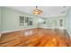 Expansive living room featuring gleaming hardwood floors, an open concept, and lots of natural light at 3132 Connemara Dr, Ormond Beach, FL 32174