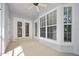 Covered patio with fan, large windows, and double doors at 3132 Connemara Dr, Ormond Beach, FL 32174