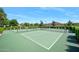 Community tennis court with net surrounded by manicured hedges at 3132 Connemara Dr, Ormond Beach, FL 32174