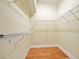 Spacious walk-in closet with wire shelving and hardwood floors for organized storage at 3132 Connemara Dr, Ormond Beach, FL 32174
