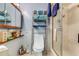 Updated bathroom with glass-enclosed shower and modern storage shelving at 466 Leland Dr, Deltona, FL 32725